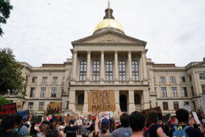 Protestors gathered in front of the Georgia State Capitol with Black Lives Matter signs.